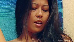 Asian brunette is playing with her hairy pussy, not knowing about a hidden camera in her bedroom