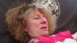 Mature blonde woman with pierced pussy and curly hair is about to experience an orgasm
