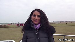 German brunette with long, curly hair is sucking her lover's dick while no one is watching them