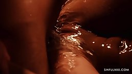 Ravishing whores are having a sensual threesome with a handsome man, in a dark room