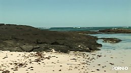 Sweet, nude blonde is relaxing on the beach and rubbing her pussy because it feels good
