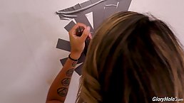 Fit blonde, Sophia Grace is rubbing her pussy while sucking a black dick through a gloryhole