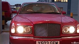 Two crazy bitches are sucking a massive cock, while on the back seat, of the car
