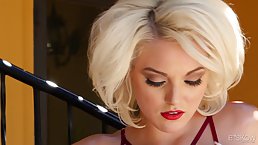 Big boobed blonde whore is lying on the bed and gentle rubbing her shaved pussy