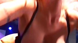 German blonde milf with a beautiful smile is performing almost naked in front of many men