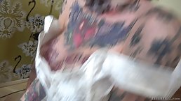 Tattooed brunette with big tits is getting DPed during an interracial gangbang in her living room