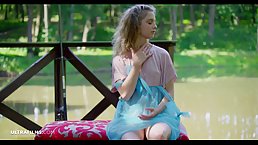 Delightful blonde girl is enjoying being naked by the river in the middle of the day