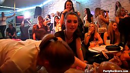 Some naughty women at the party are using an opportunity to suck a dancer's hard cock