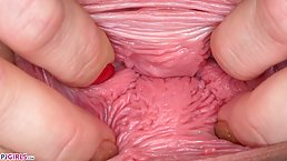 Naughty blonde is making an amazing close up of her pink pussy while stretching it