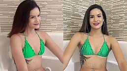 Tattooed brunette in a green bikini is posing in front of the camera and teasing a bit