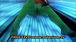 Horny woman is masturbating in the tanning bed, not knowing about a hidden camera there