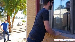 Big titted brunette, Reagan Foxx is kneeling in front of two horny guys and sucking their cocks