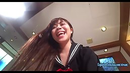 Japanese schoolgirl is wearing her uniform while spreading up and getting hammered in a hotel room