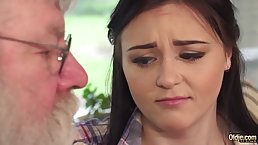 Frisky teen brunette is giving a blowjob to an elderly man before getting fucked from the back