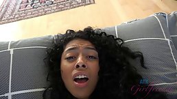 Small titted ebony babe is giving a sensual footjob to a horny man from the neighborhood