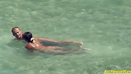 Horny couple is fucking on the beach thinking that no one is watching them in action
