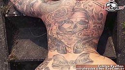 Tattooed German blonde is sucking cock in a public place and hoping to get fucked