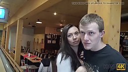 Horny guy is fucking a naughty brunette in the bowling club, in front of her guy