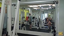Blue- eyed redhead is eagerly sucking dick in the gym, instead of doing her workout routine