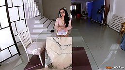 Ms. Bellucci is kneeling in front of her lover and giving him an amazing blowjob