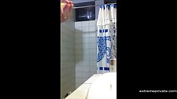 Mature blonde woman got naked in the bathroom, not knowing about a hidden camera there