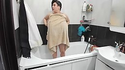 Fat milf with massive tits, Carol is having a shower in front of the camera