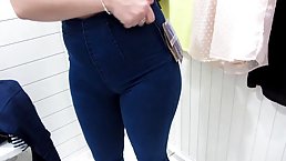 Chubby brunette is changing clothes and pissing in front of a hidden camera, in the mall