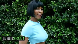 Ebony chick is squeezing her big boobs around a rock hard cock to make it explode