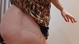 Big butt woman lifts her dress and takes off her panties, in front of the camera