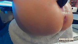 Horny woman is masturbating with a huge, black vibrator and drilling both of her holes