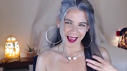 Mature lady with big boobs is posing topless in front of the camera, just for fun