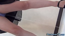 Ladies are pissing in the public toilet not knowing about a hidden camera near them