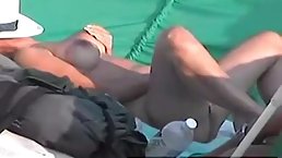 Dirty minded woman with big, firm tits is playing with herself in a public place