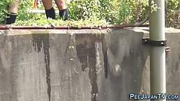 Asian girls are pissing in the nature not knowing that someone is making a video of them