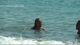 Naked ladies are relaxing on the beach knowing that people might be staring at them