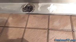 Asian brunette is peeing in a public place in the middle of the day, just for fun