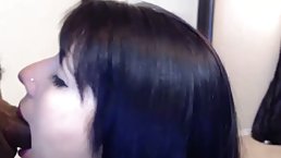 Blue- eyed brunette is gently sucking a big, black dick, while kneeling on the floor