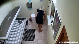 Sweet blonde is masturbating in the solarium, thinking that no one will see it happening