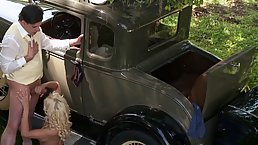 Gorgeous blonde woman with big boobs is holding a gun and getting ready to suck dick