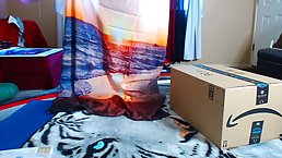 Red haired chick is wearing short pants and tiny top while unboxing her new stuff