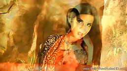 Beautiful, Indian woman is posing in front of the camera and slowly taking off her clothes