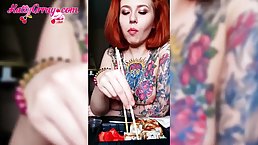 Tattooed honey with red hair is squeezing her nice tits after eating in front of the camera