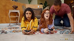 Two gamer girls are playing their video games while their horny neighbor is fucking them