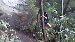Sluty brunette is giving a blowjob to a random stranger, while they are alone in the forest