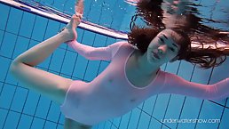 Flexible chick, Roxalana Cheh is wearing a sheer costume while playing in the swimming pool
