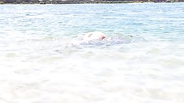 Great looking girl is slowly taking off her clothes, on the beach, during the day