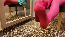 Naughty, amateur teen is displaying her feet in pink stockings, in front of the camera
