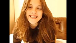 Adorable, amateur babe in a sheer blouse is about to start masturbating, in front of the camera