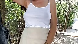 Busty, amateur brunette is fingering her pussy in front of the camera, in the backyard