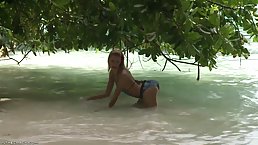 Sweet babe got naked on the beach and started masturbating with a pink sex toy